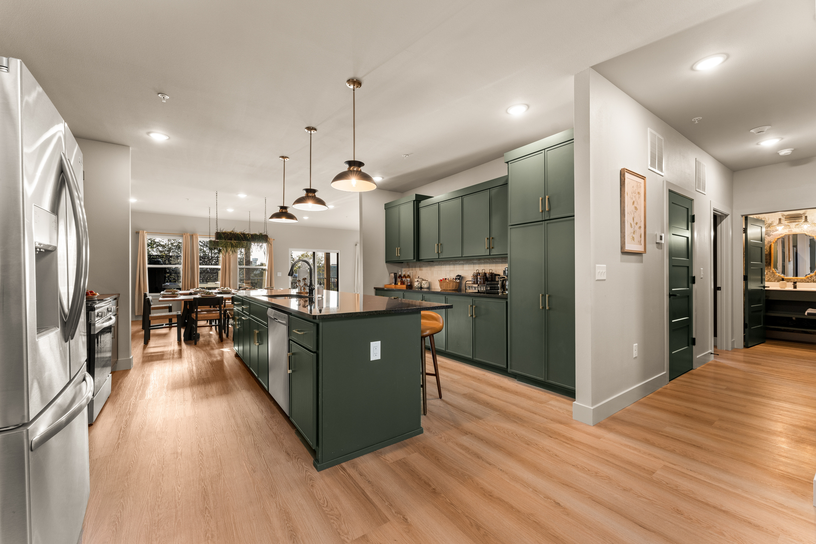 The open kitchen flows seamlessly into the surrounding living spaces for easy group entertaining.
