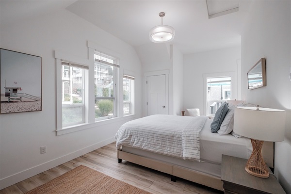 A beautifully designed guest bedroom with soft linens and calming coastal accents.