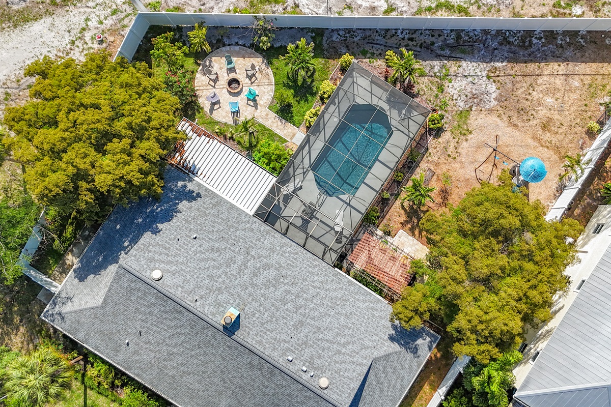 Enjoy year-round sunshine in our relaxing home with a heated private pool with a screened sitting lounge, a BBQ grilling area, and a backyard fire pit. 