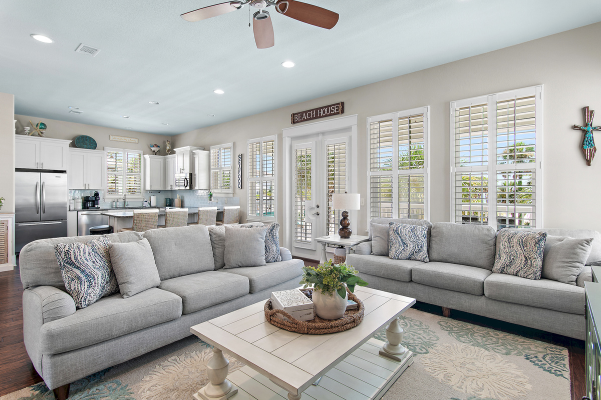 Relax in a bright, coastal-inspired living room designed for comfort after a day at the beach.