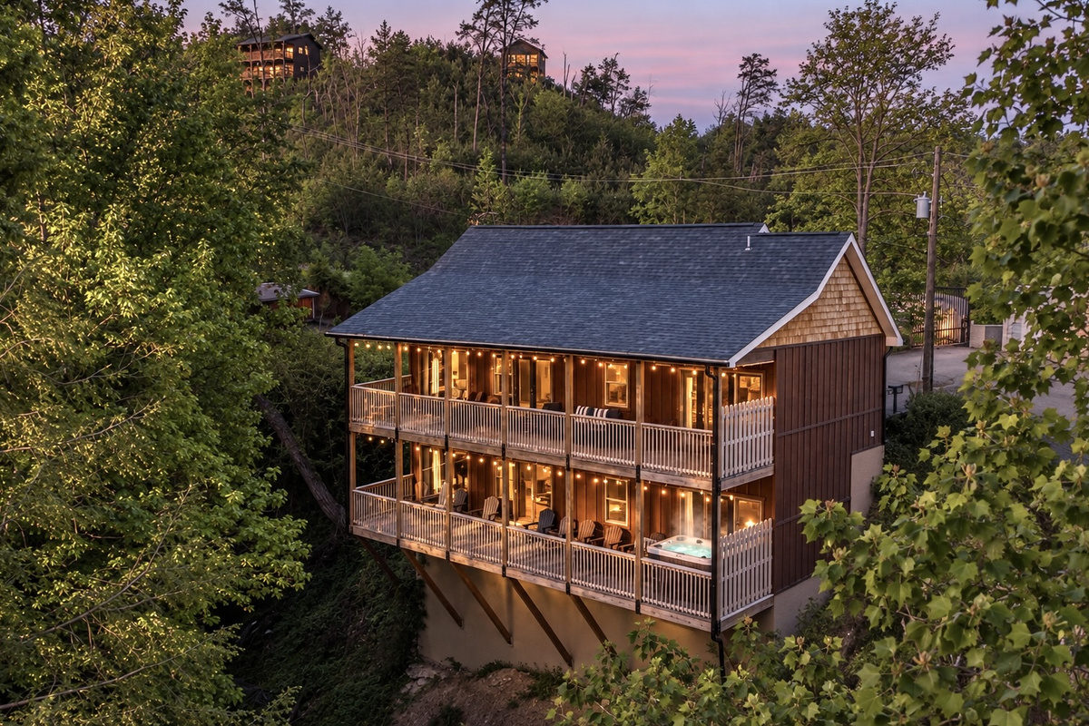 Twin stacked decks span the back, strung with bistro bulbs that glow after dark.