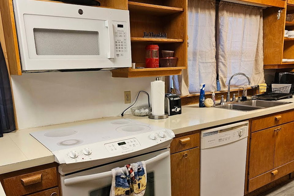 Full kitchen with stove, oven, microwave, refrigerator, and dishwasher. Plates, cups, silverware, pots, pans, and most essentials.