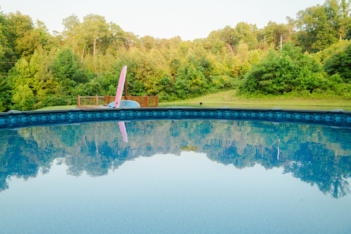 Unwind by the above-ground pool while taking in peaceful views of the pond and surrounding woods.
