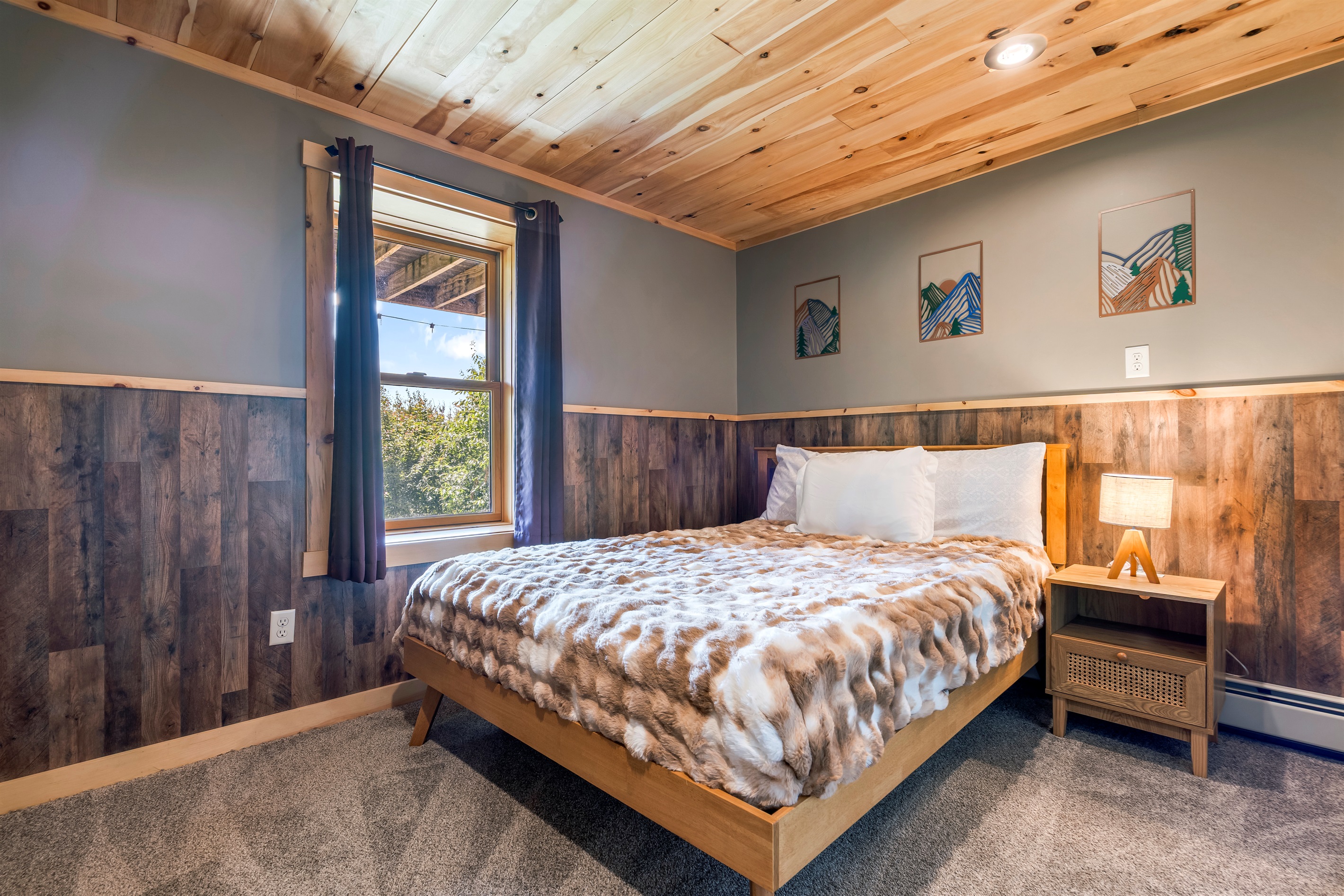 Extra sleeping space downstairs with a queen bed and attached bunk room.