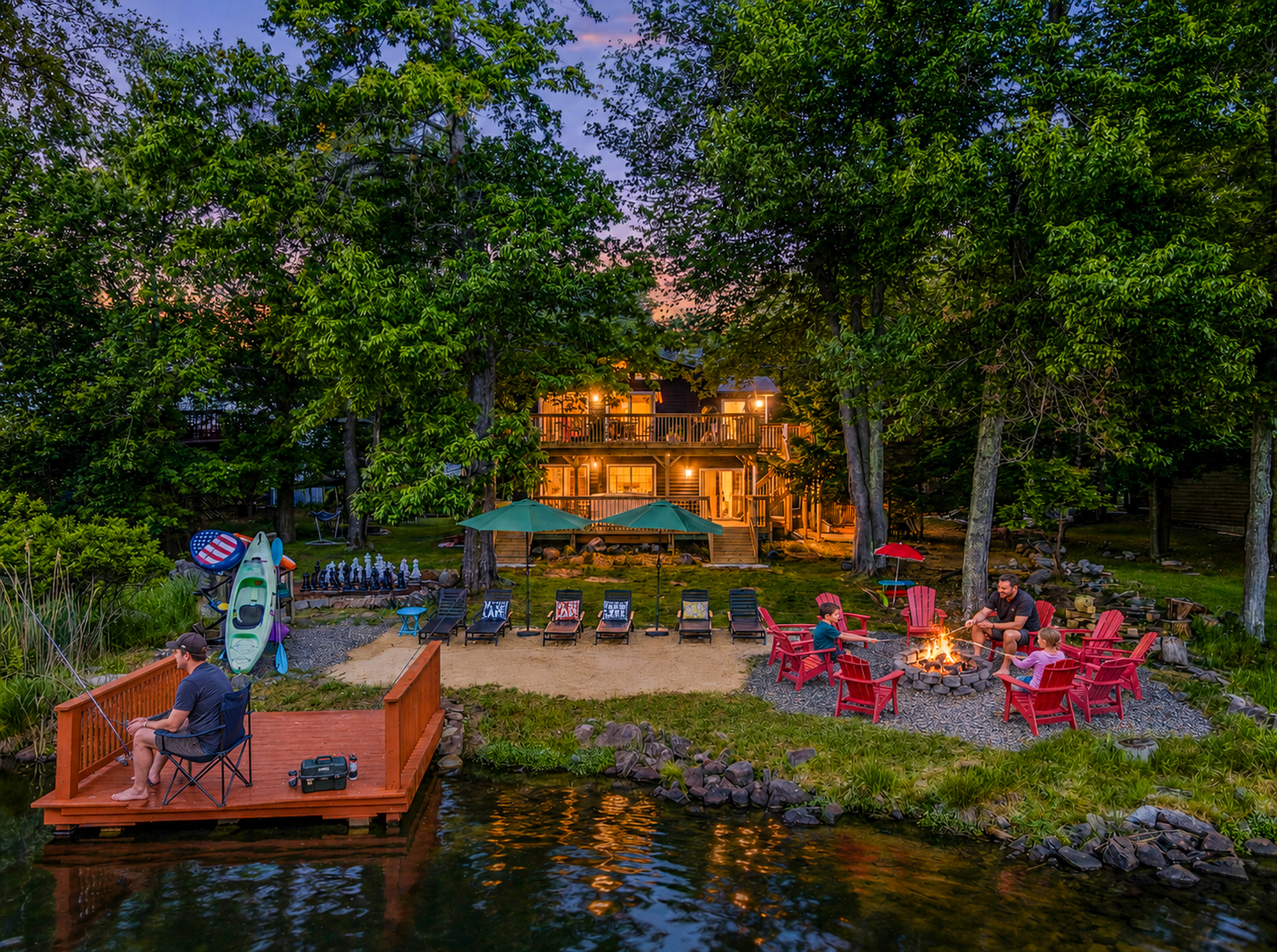  Élevé Lake Lodge at dusk — warm evening light bathes the lakefront yard, dock, and fire pit seating on Lake Carobeth