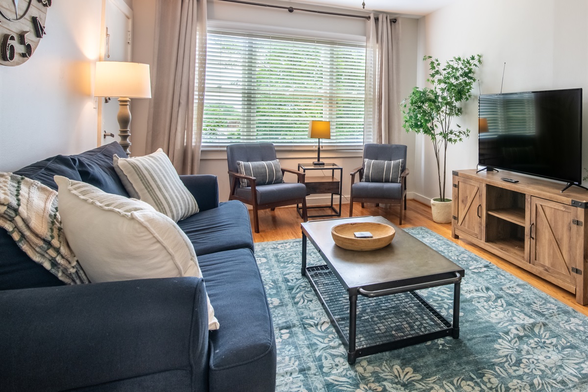 Sun-filled living area with a mix of cozy and modern furnishings for your comfort.
