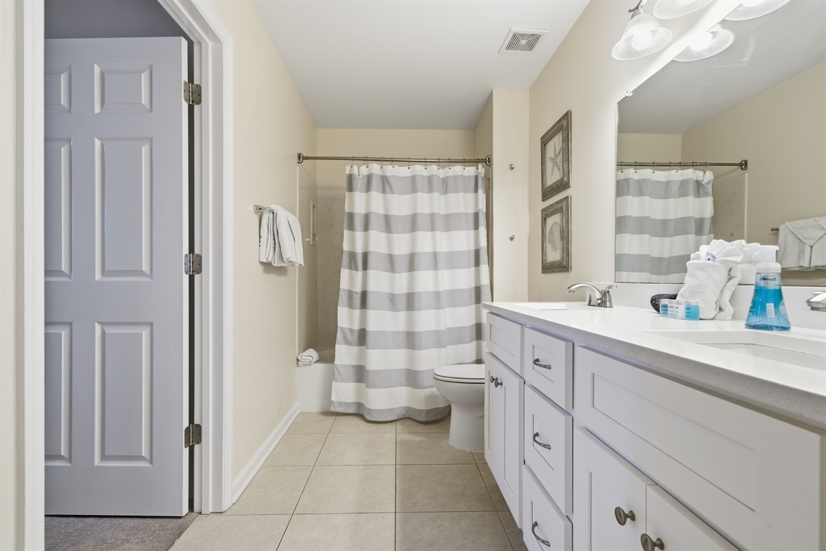 Perfect for families, this bathroom offers ample counter space and easy access from the bedroom or hallway.