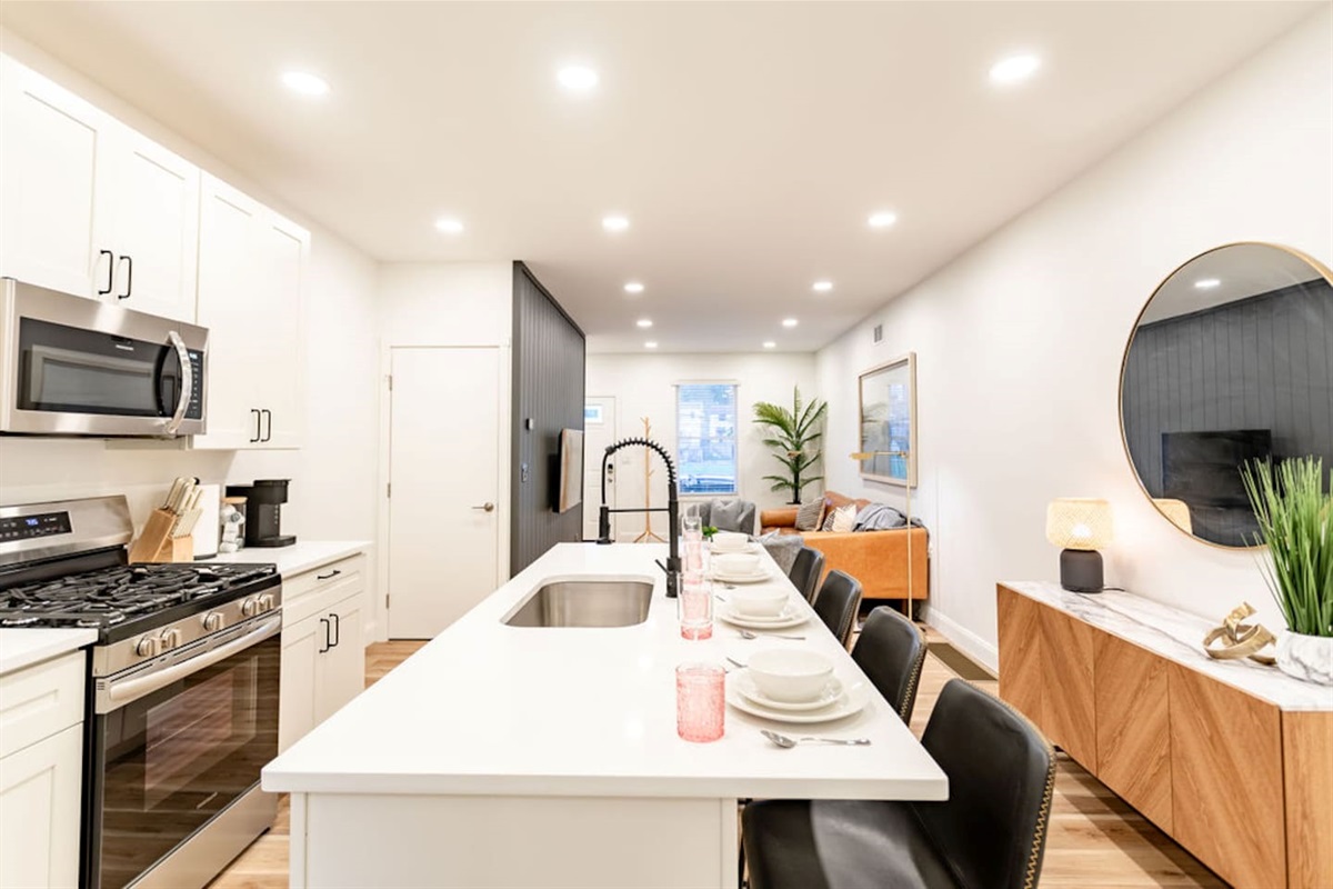Full kitchen with counter dining and a sink, offering everything you need for cooking and enjoying meals.