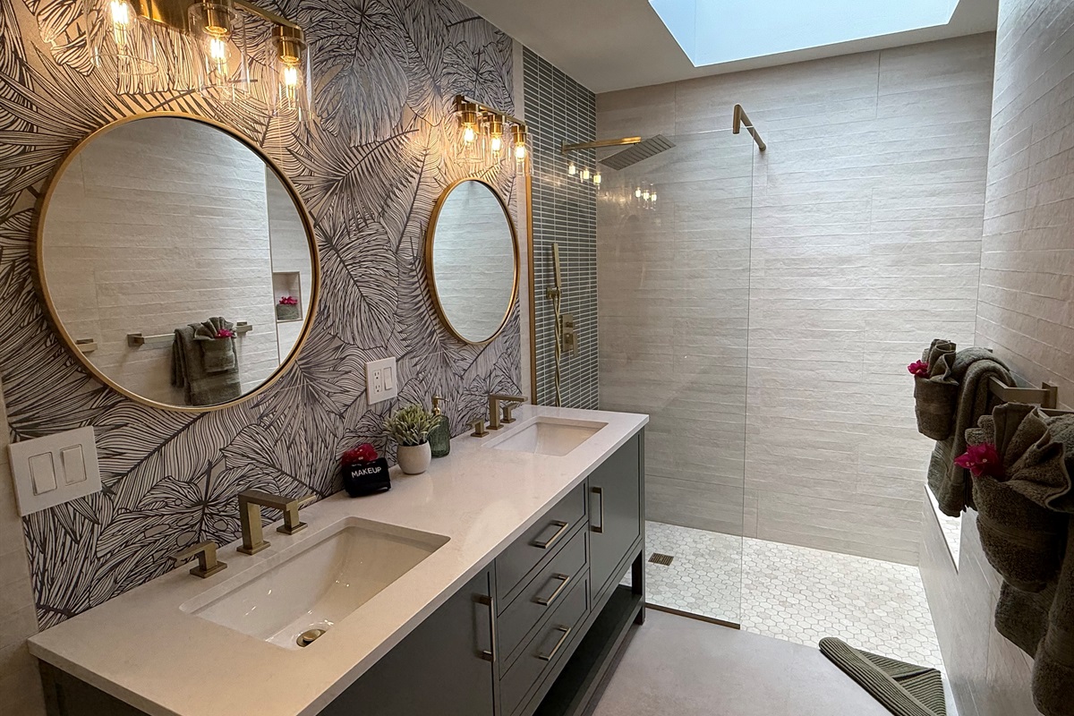 Fully renovated bathroom with double vanities, rain shower and skylight and bidet toilet