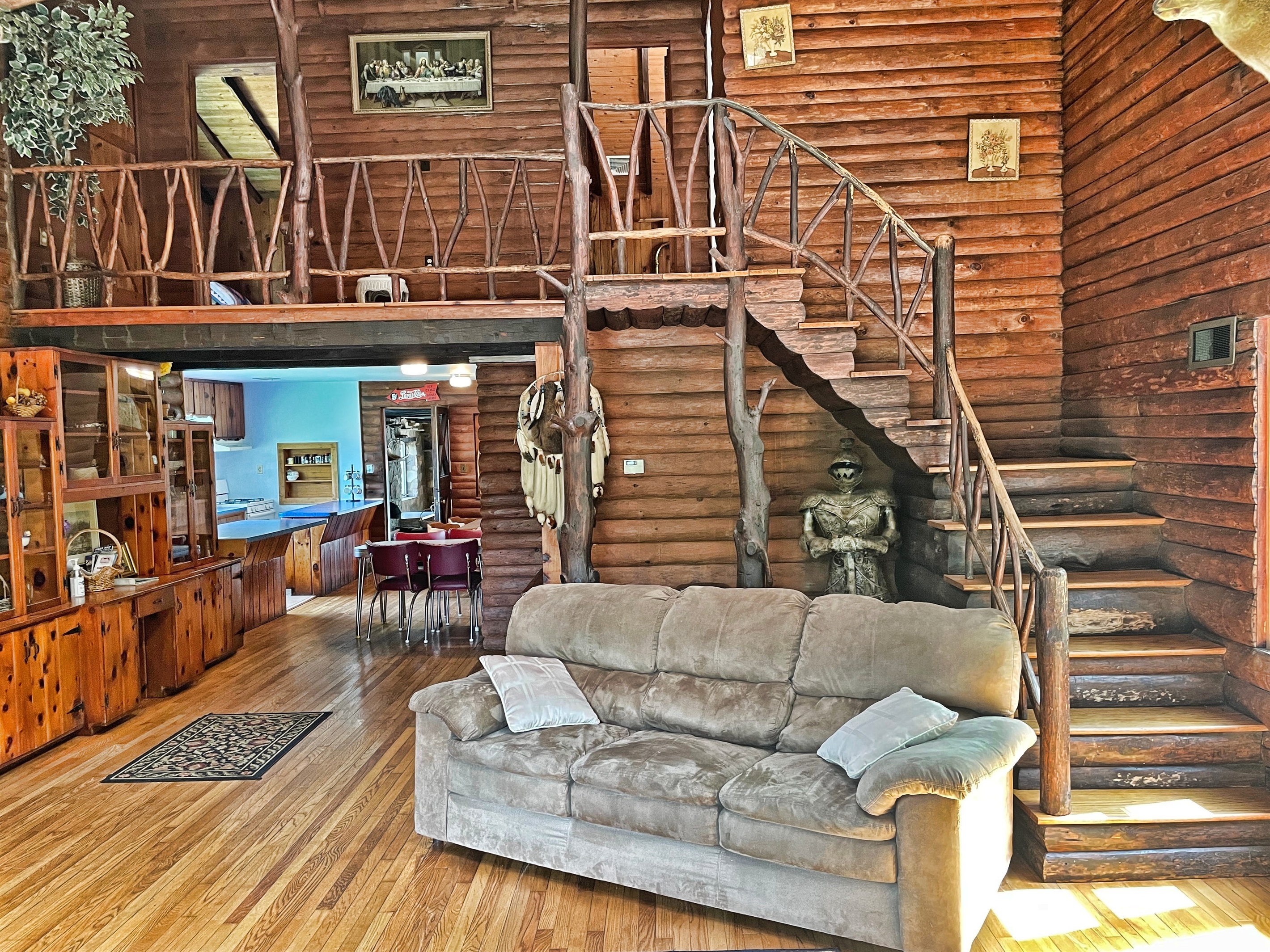 View from living room into kitchen. The stairwell leads to 2nd floor bedrooms and bathrooms.