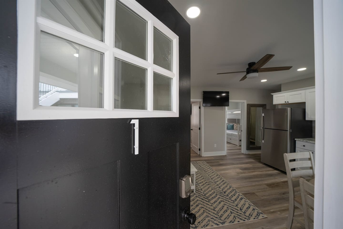 Private entry opens into a bright, open interior with clear sightlines to the living area and kitchen. The layout feels welcoming and efficient, offering an easy transition from arrival to settling in comfortably.
