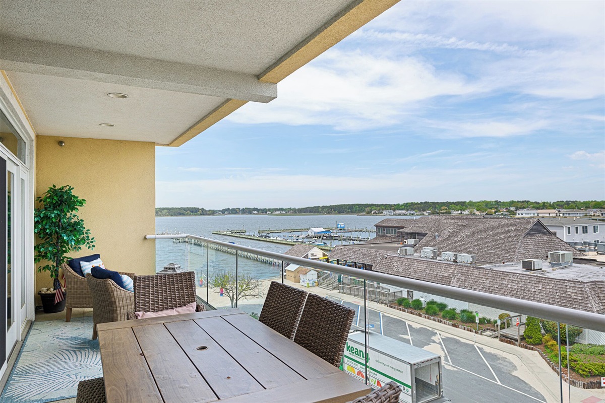 outdoor dining on balcony overlooking bay