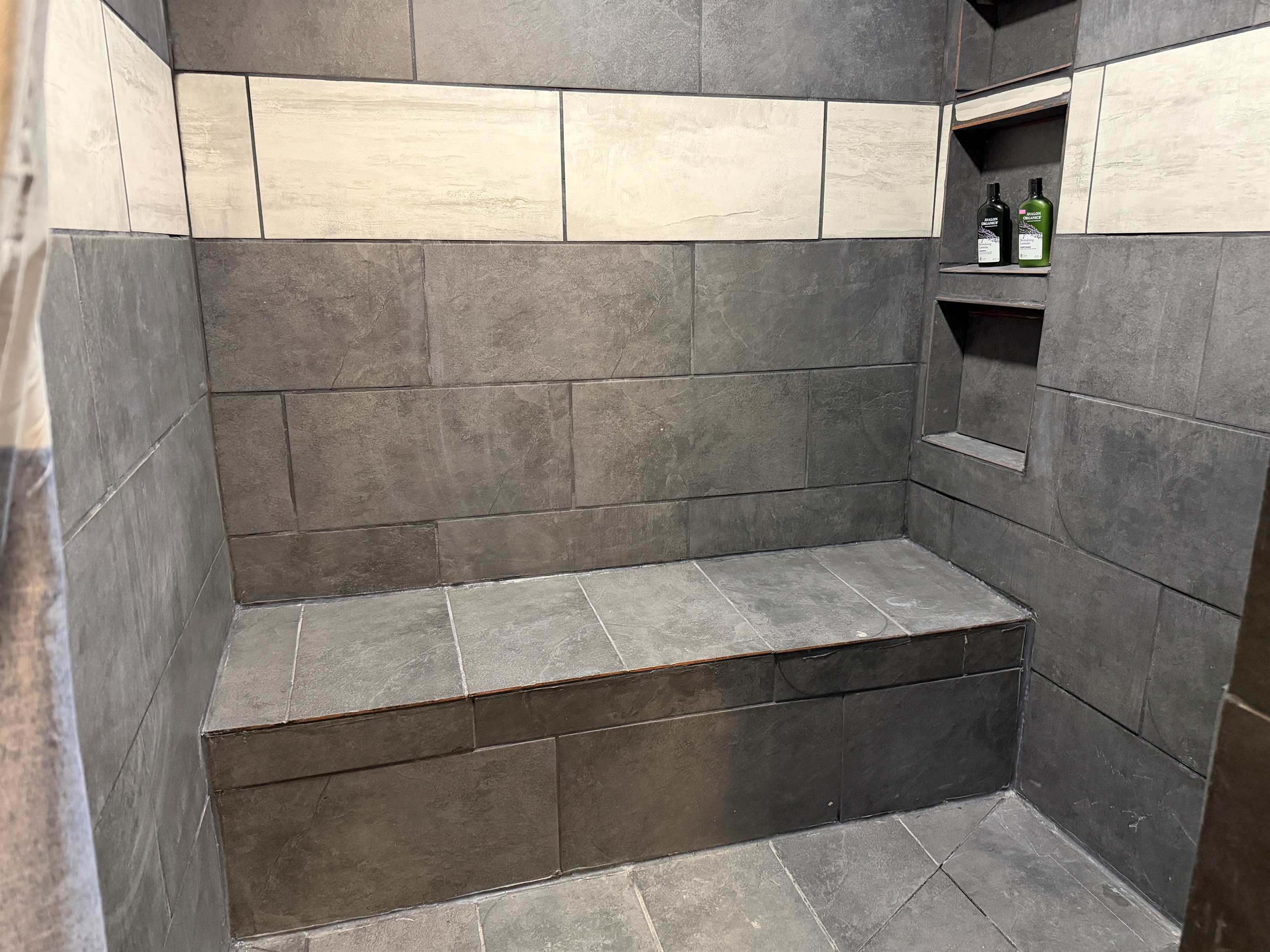 The large tile shower is accessible-friendly.