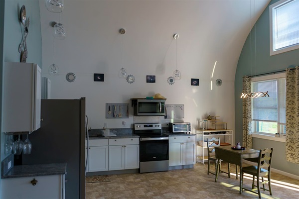 Full kitchen with pots, pans, utensils, toaster oven & microwave. The pantry has staples like Bisquick, oil for the pans, spices & instant oatmeal. Coffee & tea is always stocked. A cozy kitchen table is lit by the sun. 