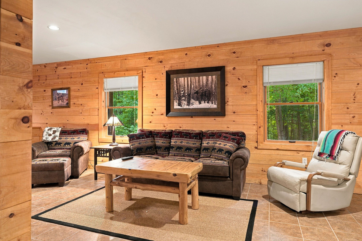 Spacious lower-level family room with comfortable seating for games, movies, or conversation.