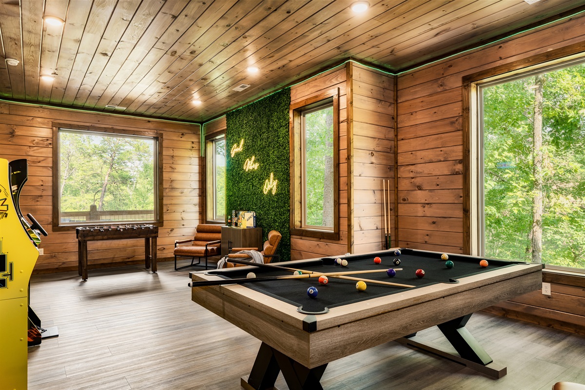 Game room with pool table, foosball table, arcades, board games, theater and half bath