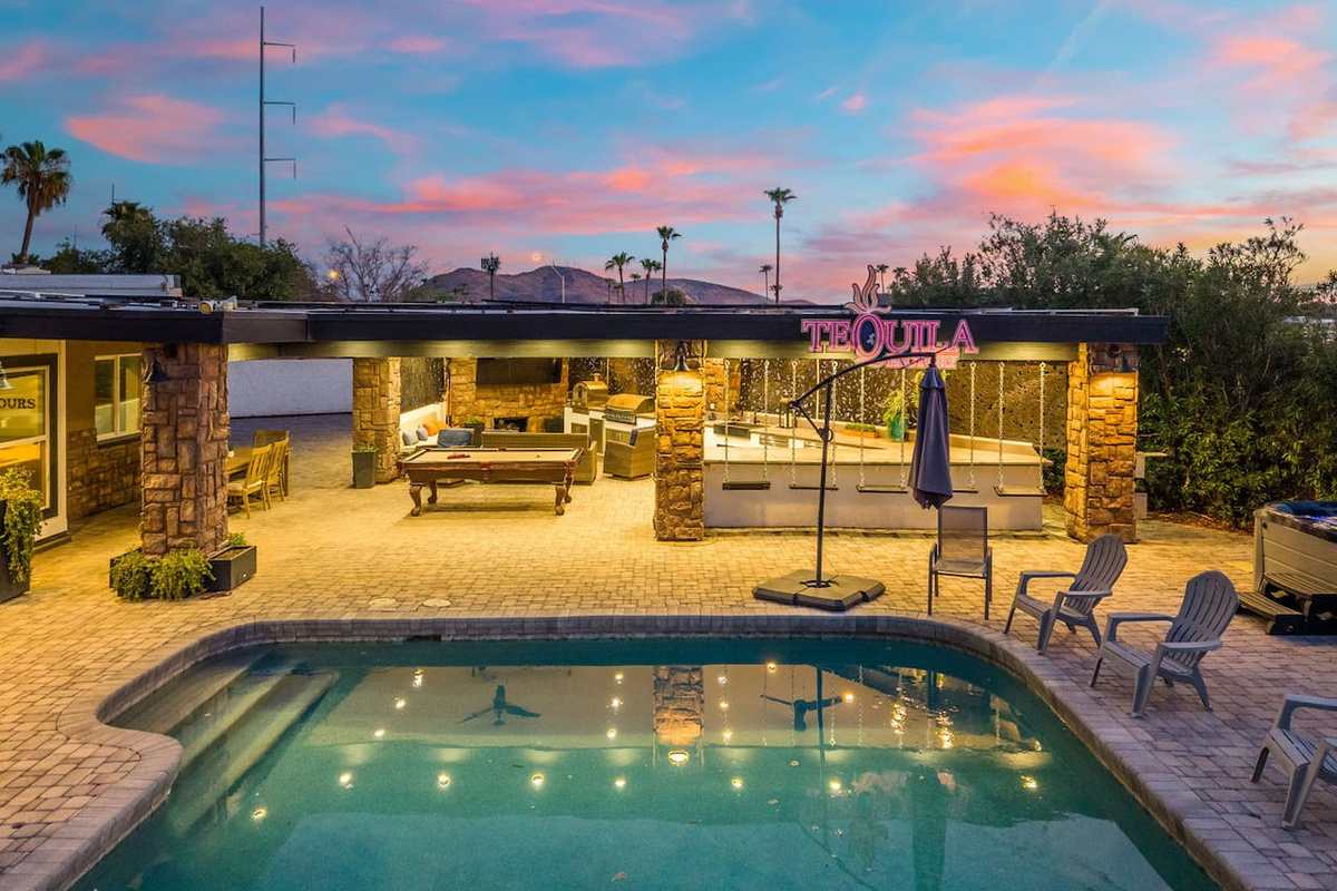 ￼￼A twilight pool glow, string lights, and a covered patio lounge set the scene for unforgettable desert evenings.
