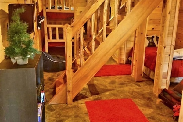 lower level with bunk beds, twin bed and queen futon bed.
