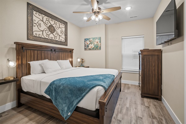 Bedroom #5 has a king size bed, dresser, TV and closet.