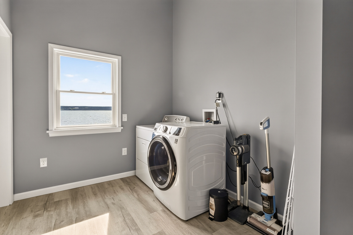 Laundry area with washer and cleaning supplies