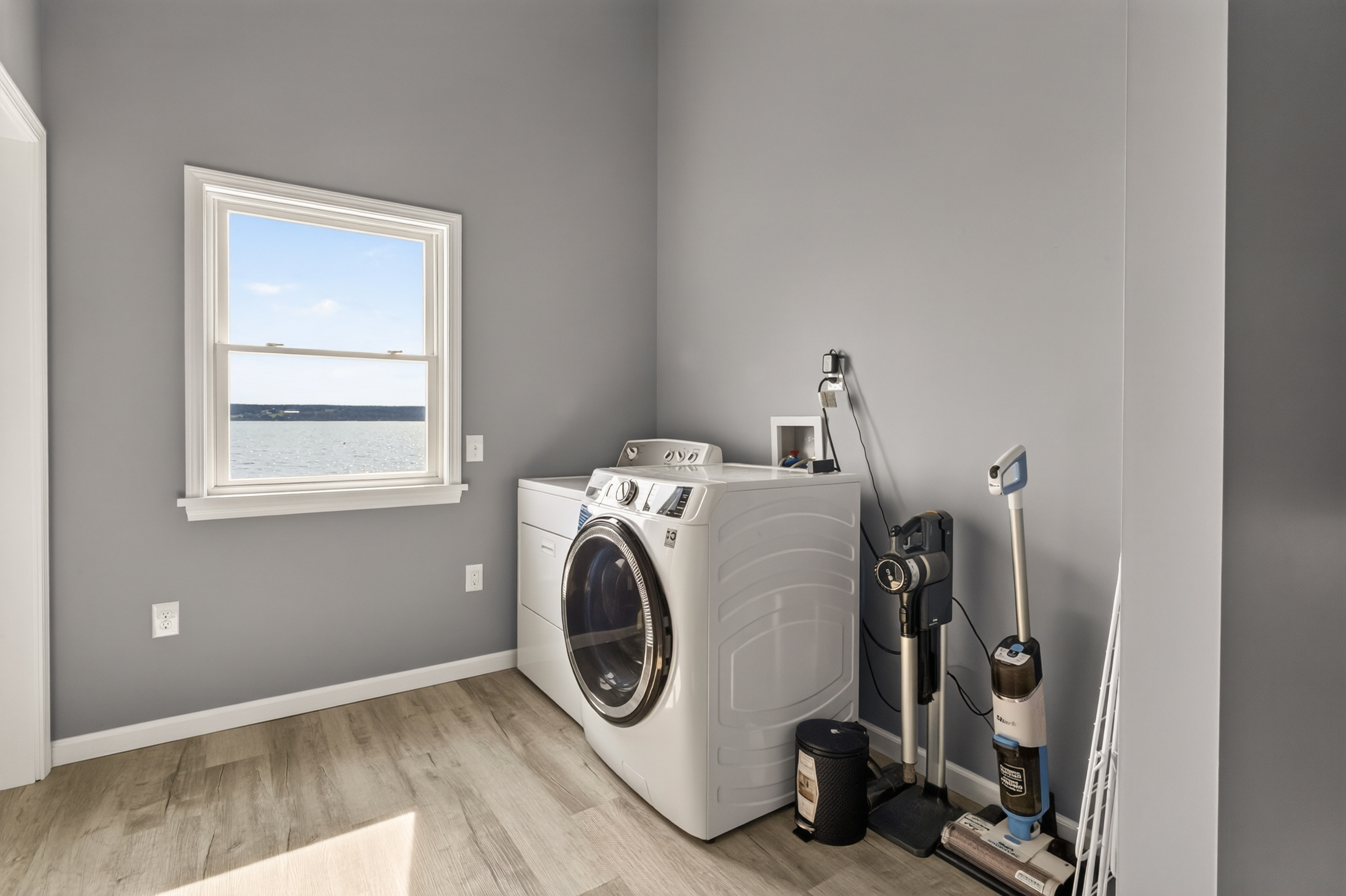 Laundry area with washer and cleaning supplies
