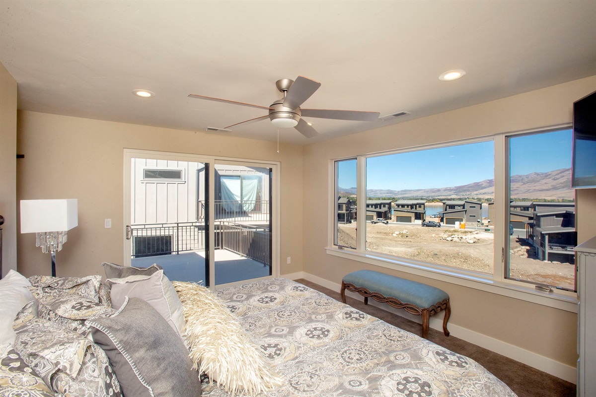 Peaceful bedroom retreat with large windows and natural light overlooking Ogden Valley.