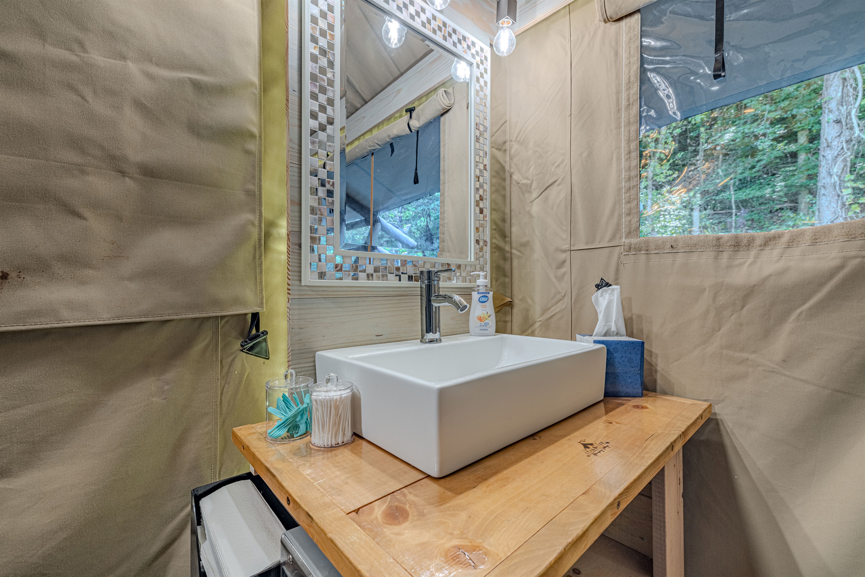 A bright and beautiful spot for the essentials. Everything you need is right here—from soft lighting to ample counter space—making your glamping experience truly hassle-free and luxurious.