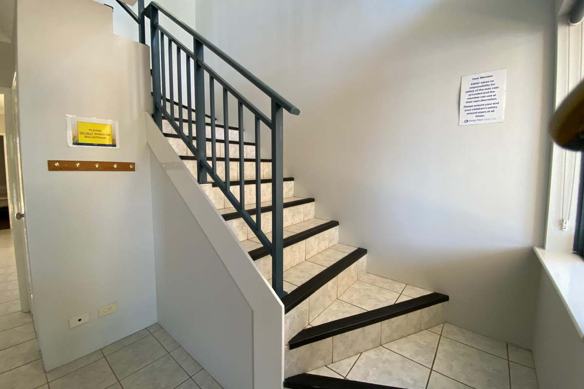 Staircase from front door up to the kitchen