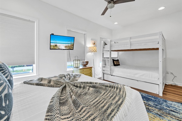 Secondary queen bedroom with queen over queen bunk beds and ensuite bath