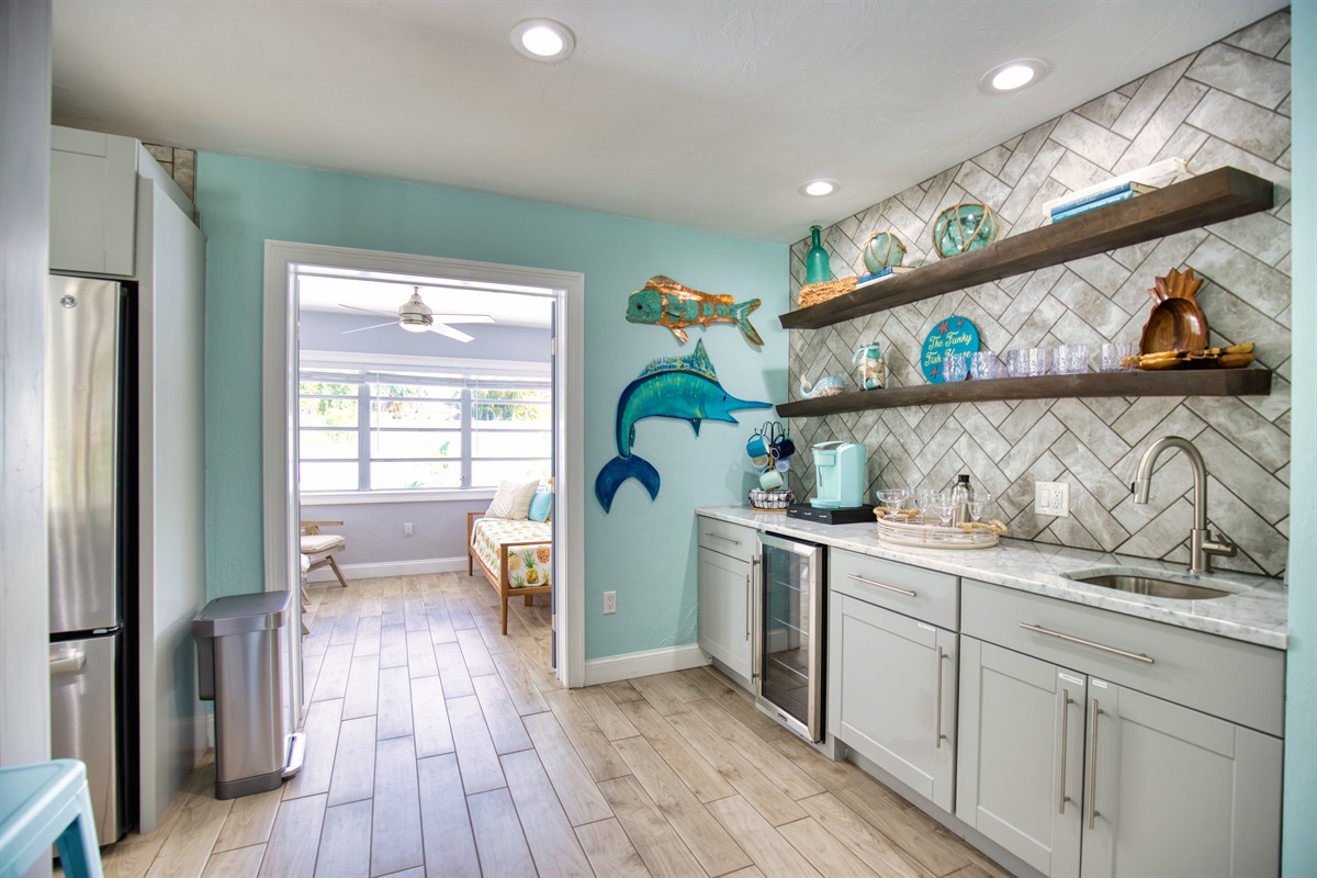 The WET BAR features a beverage cooler and Keurig. K-Pods, creamer and sugar are included.