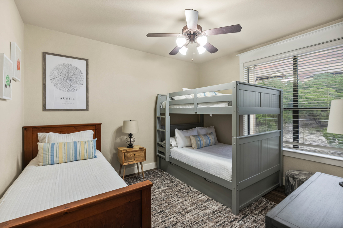 A flexible sleeping space for kids or groups featuring a full-over-full bunk bed with a twin trundle, plus a separate twin bed.