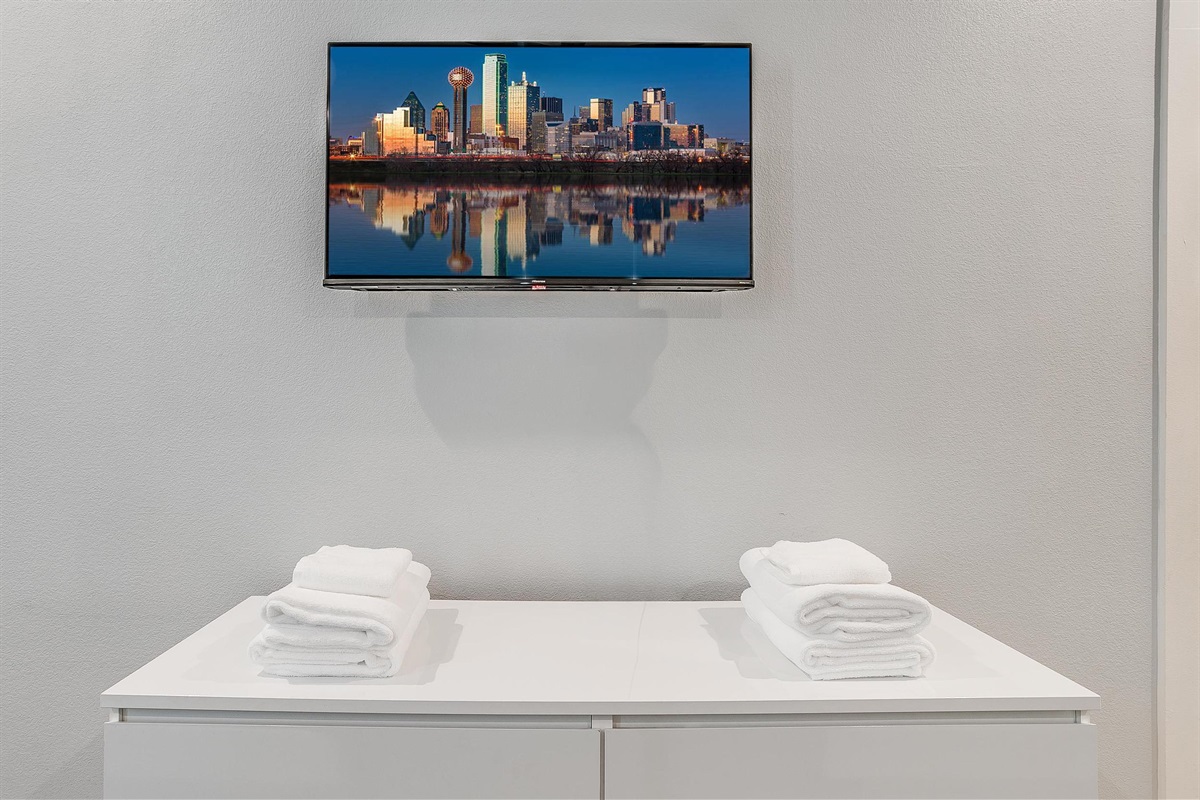 Smart TV with vibrant cityscape artwork—perfect for winding down.