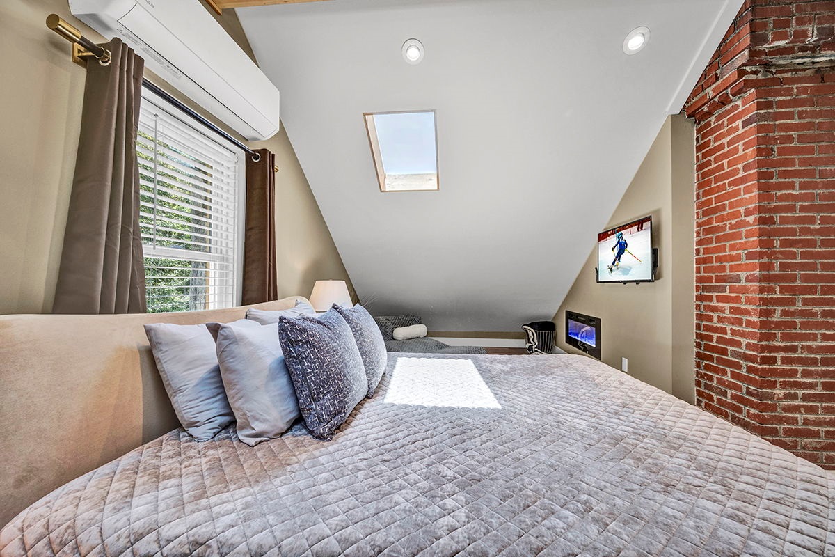 Master Bedroom with King Bed, 42-inch Smart TV, Fireplace, sound machine, blackout curtains and cozy reading chair