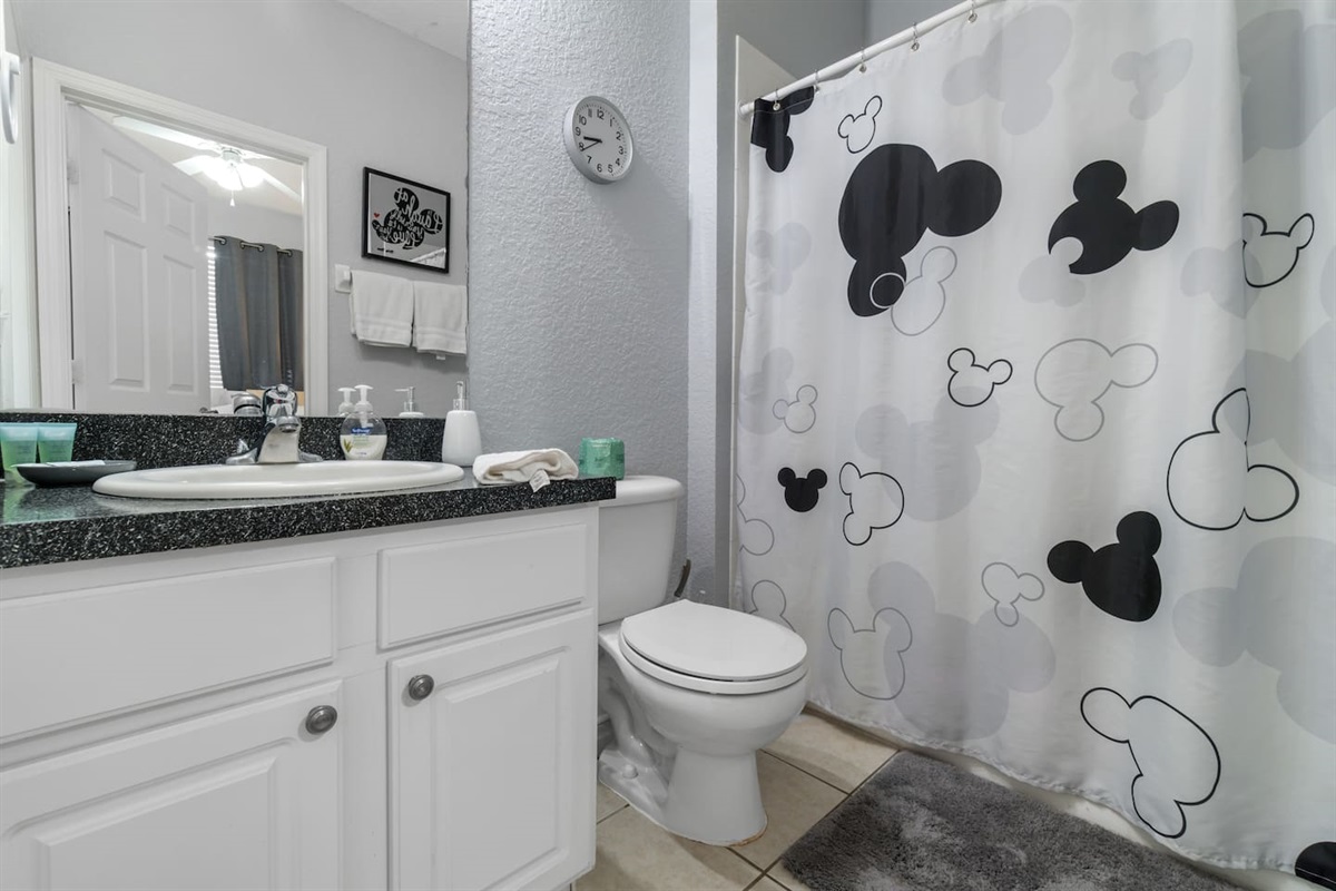 - Stylish bathroom with granite vanity and large mirror for a polished look  
- Mickey themed shower curtain adds a playful Disney touch to the space  
- Perfect mix of fun and function for guests of all ages to enjoy  