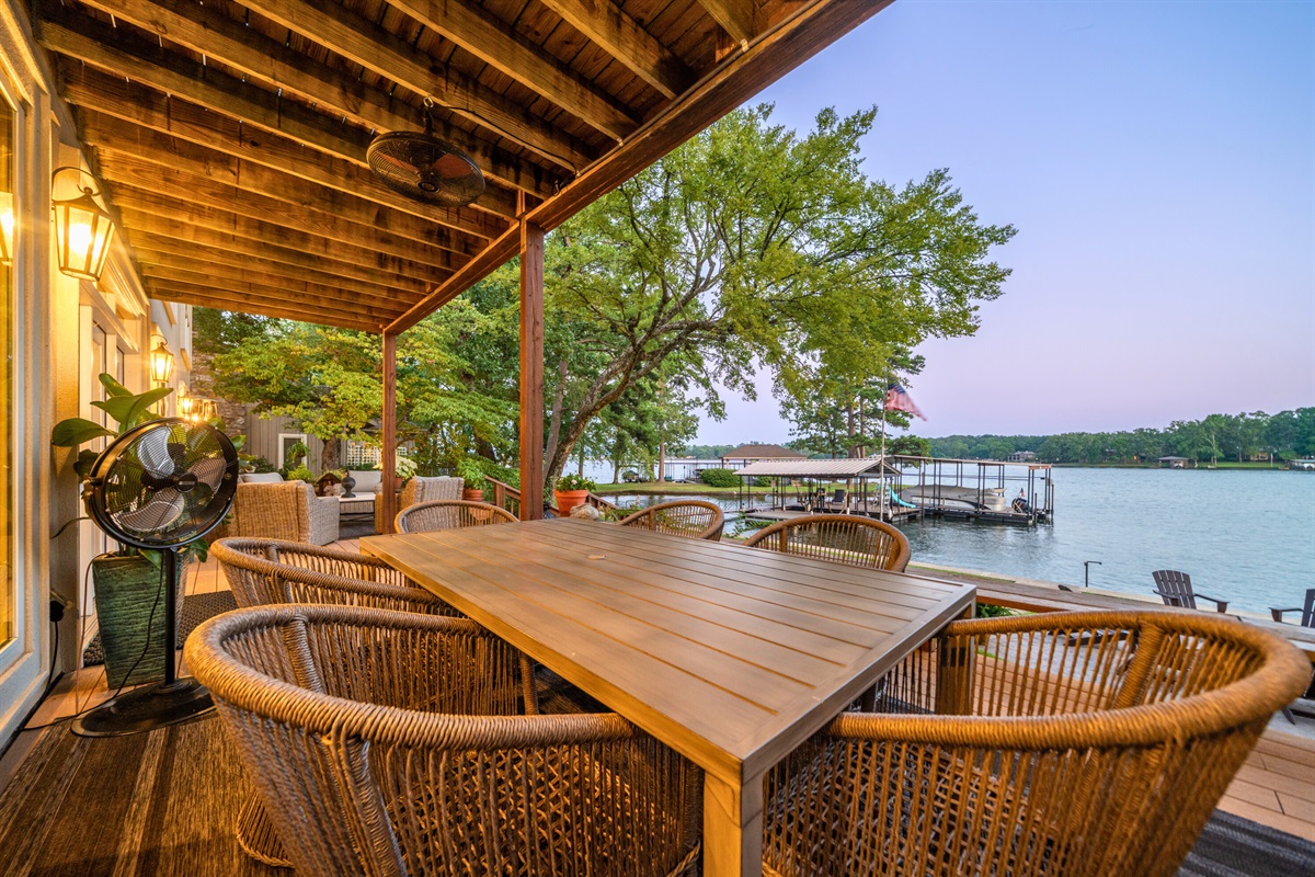 Enjoy meals or drinks on this covered deck, just steps from the lake &mdash; complete with fan and evening glow.