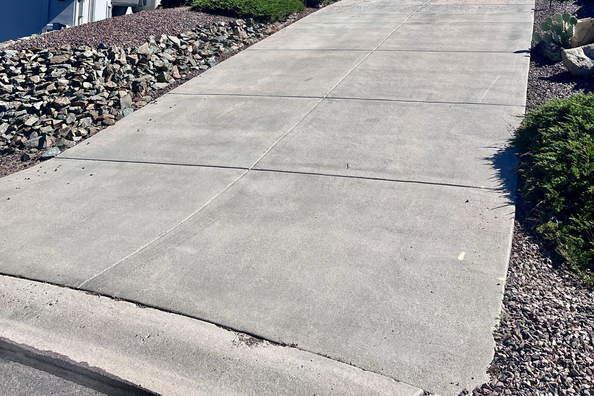 The exterior of the home exudes a sense of welcome and belonging. The well-lit driveway and garage entrance provide a convenient and safe arrival experience