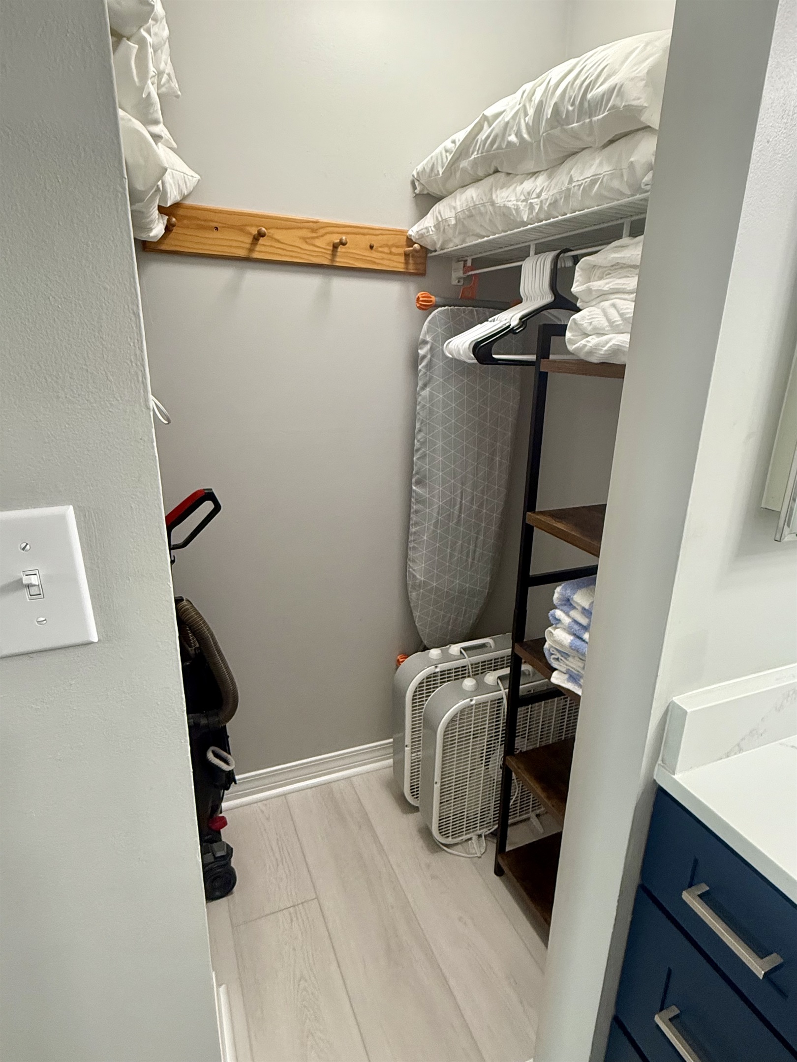 Walk-in Closet with Iron, Ironing Board, and Extra Fans