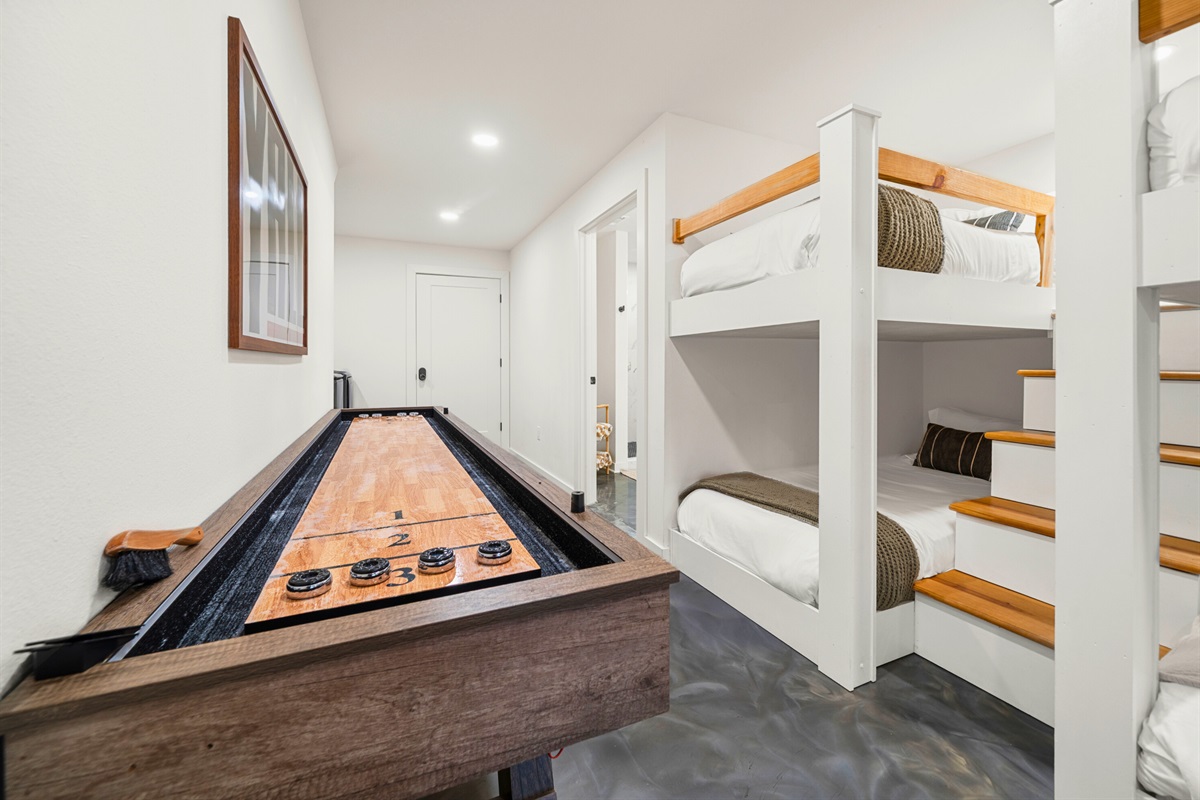 Bunk room with cozy built-in beds and shuffleboard table for fun nights in.