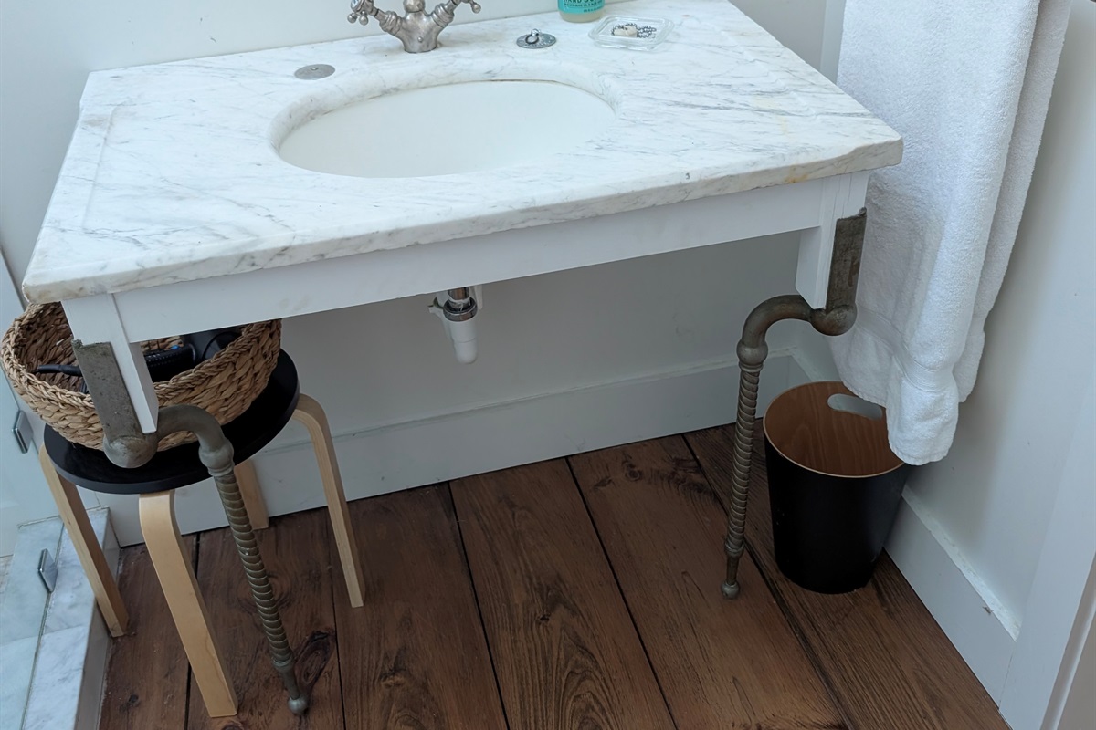 Vintage-Inspired Bathroom Vanity
“Thoughtfully designed bathroom with marble vanity and timeless fixtures.”