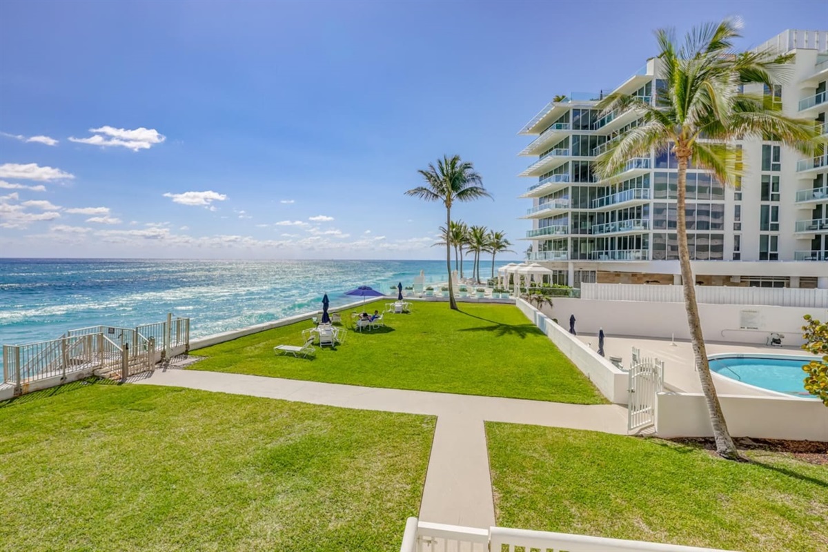 Rare Green Space: A lush, manicured lawn area directly overlooking the Atlantic—a unique feature for an Island property, complete with loungers and umbrellas.