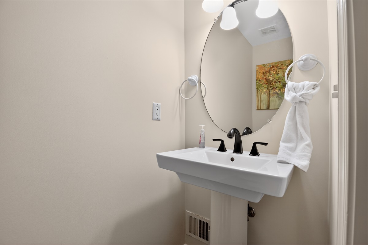 Half Bath — Main Level Powder Room, Convenient for Guests, Clean and Well-Lit
