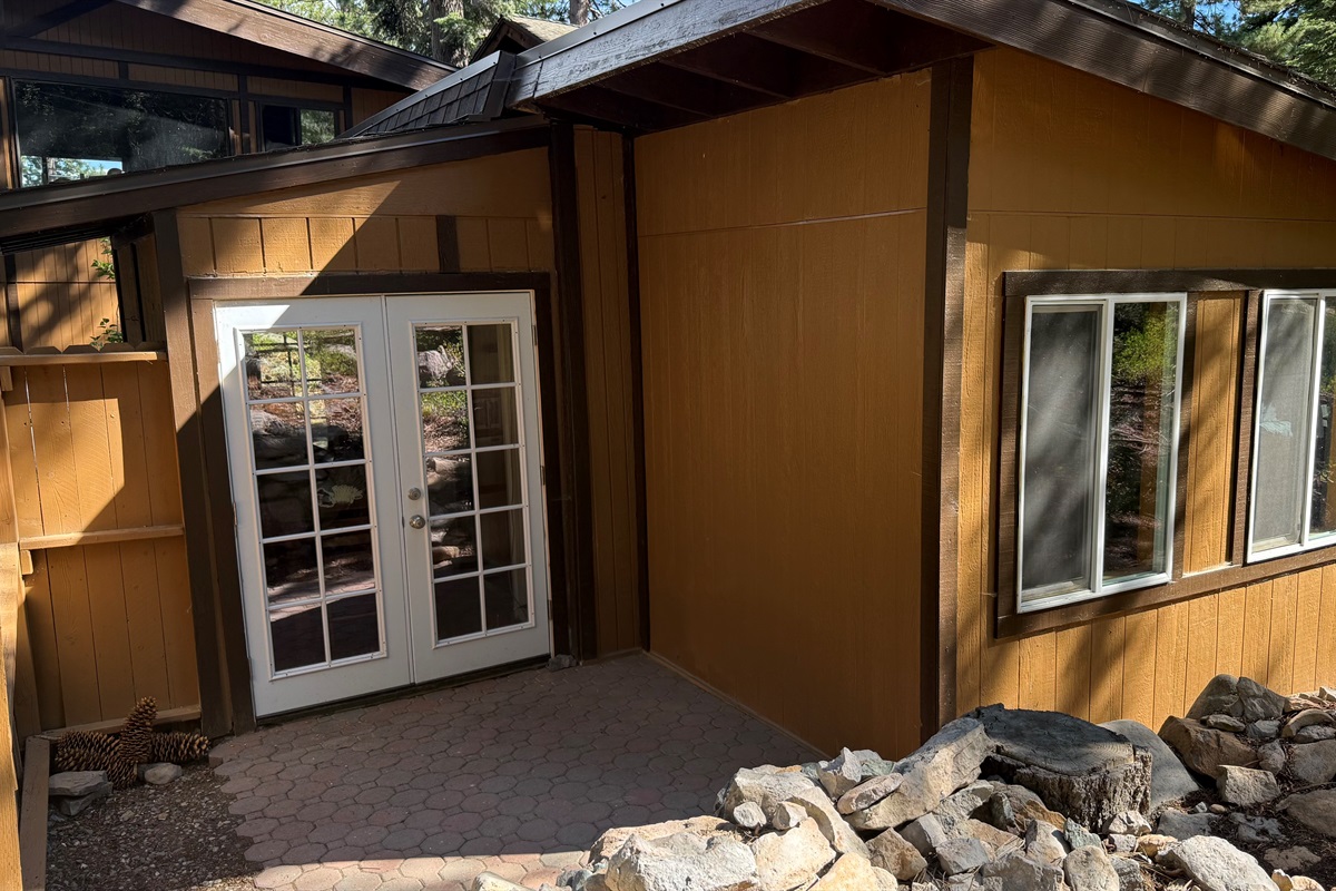 nviting entryway with French doors leading into your private North Lake Tahoe retreat, surrounded by natural rock landscaping and mountain charm