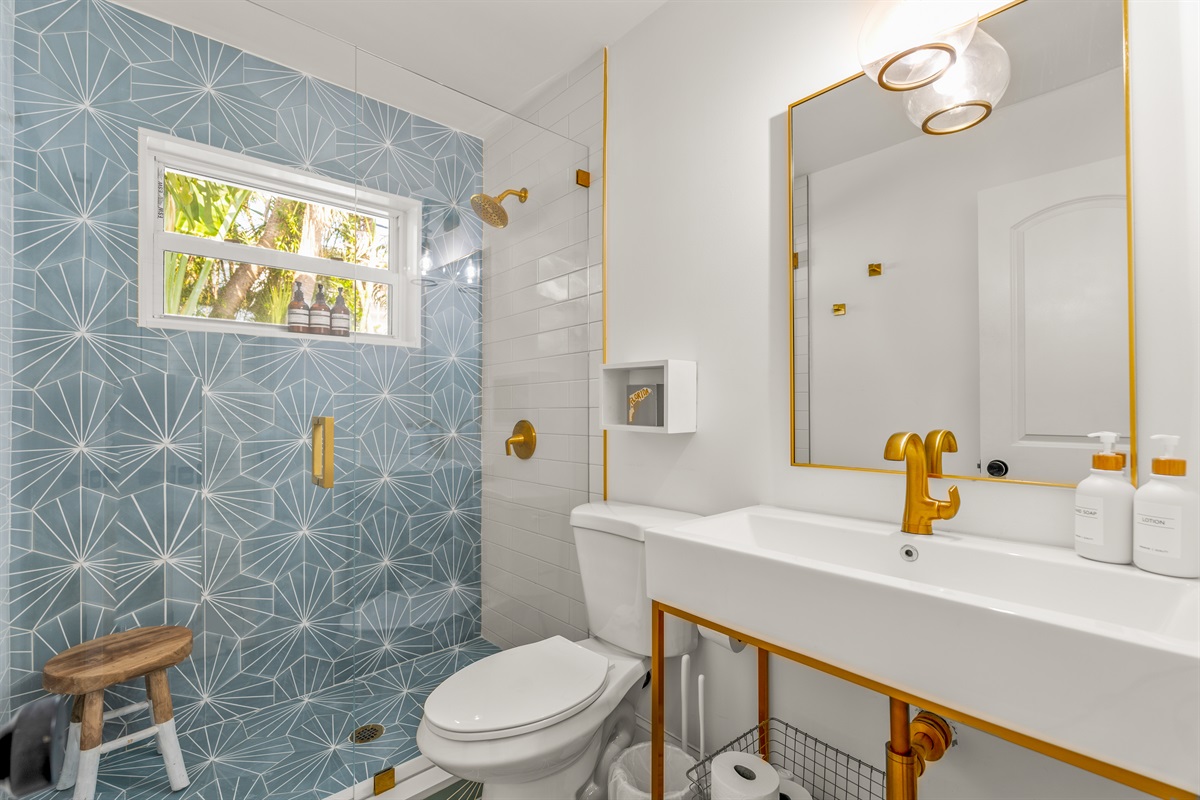 Step into a bright, modern bath designed with eye-catching geometric walls and clean lines for a fresh, spa-like feel.