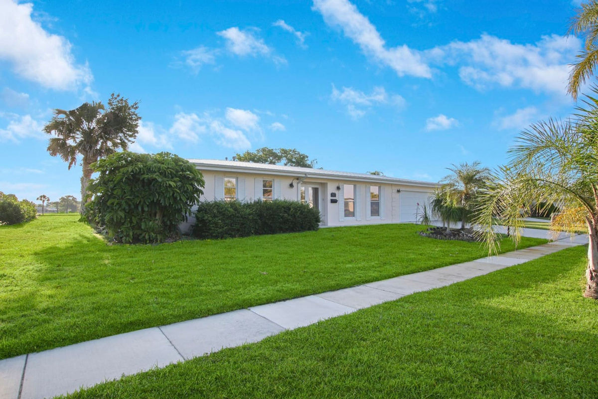 Accessible and lighted front walk with wide driveway and no steps.