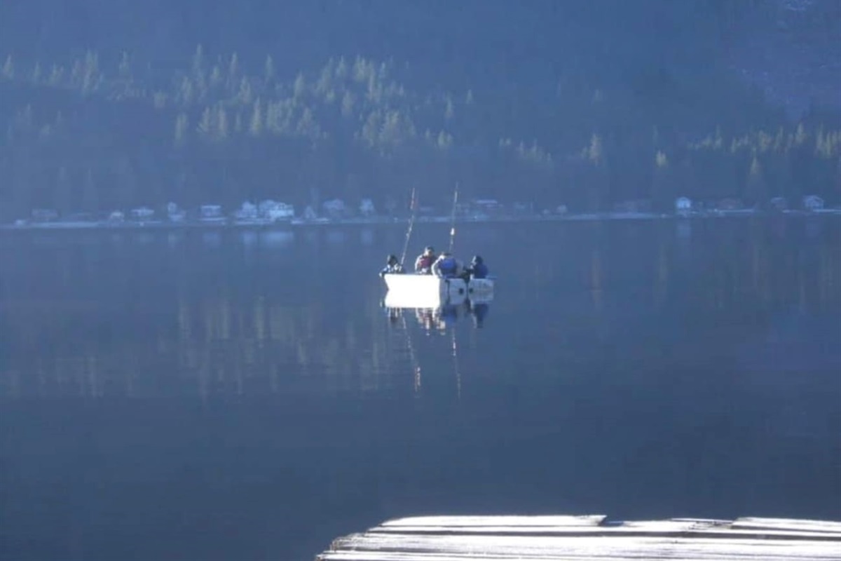 Calm lake with a fisherman in the distance.