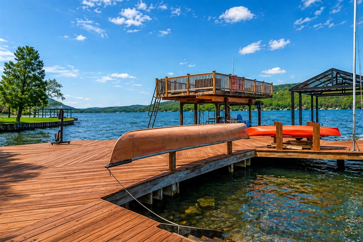 Expansive lakefront deck with seating, a canoe, and stunning water views—your private Finger Lakes retreat. 🚣‍♀️🌊☀️