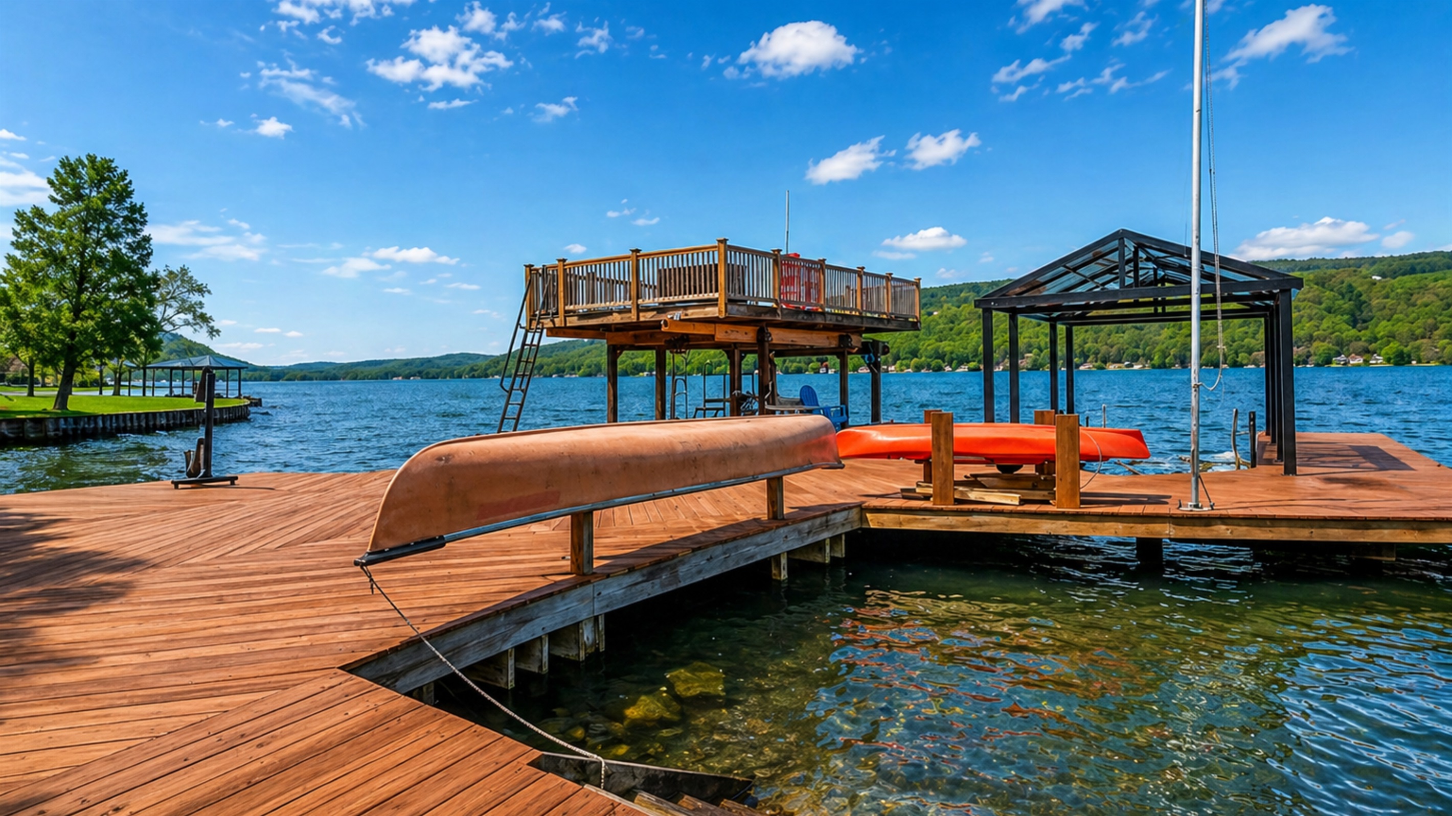 Expansive lakefront deck with seating, a canoe, and stunning water views—your private Finger Lakes retreat. 🚣‍♀️🌊☀️