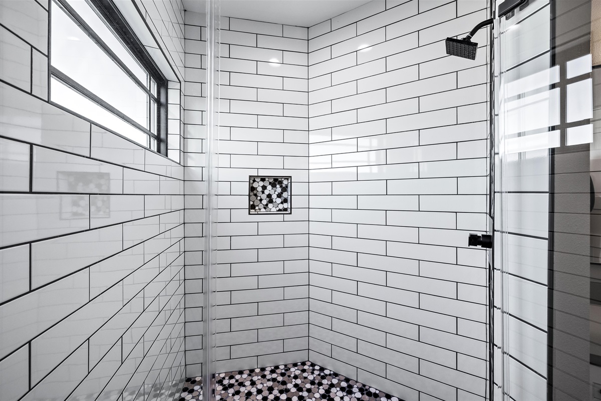 Shower Retreat: Modern tiled shower with stylish accents for a refreshing escape!