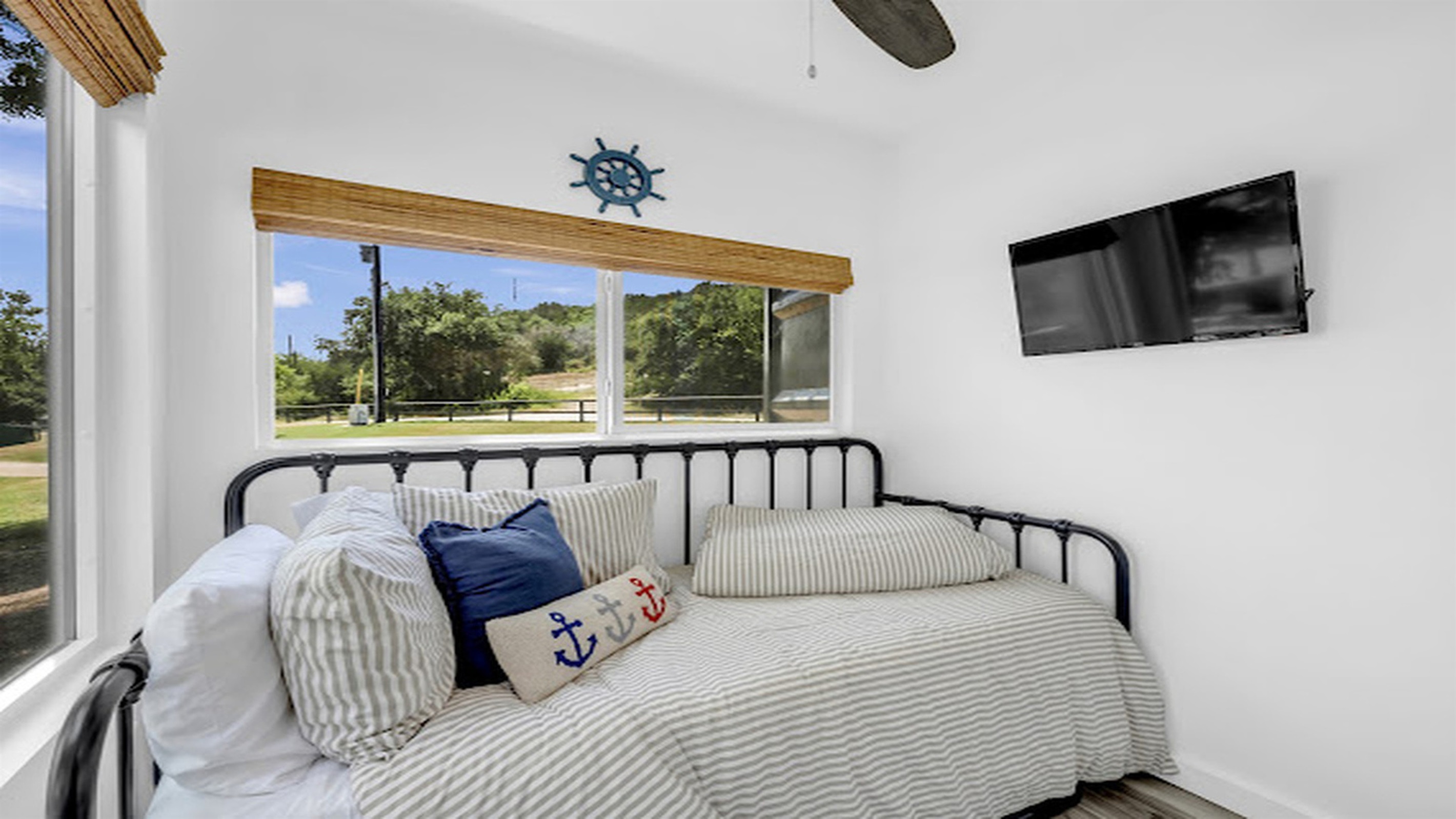 Sunlit comfort with cozy bedding and a peaceful setting.