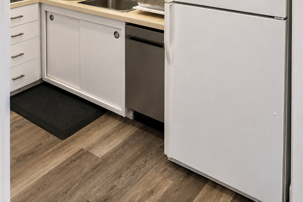 Fully equipped kitchen with a dishwasher, refrigerator, microwave, coffee maker, and small appliances for easy meal prep and everyday convenience.